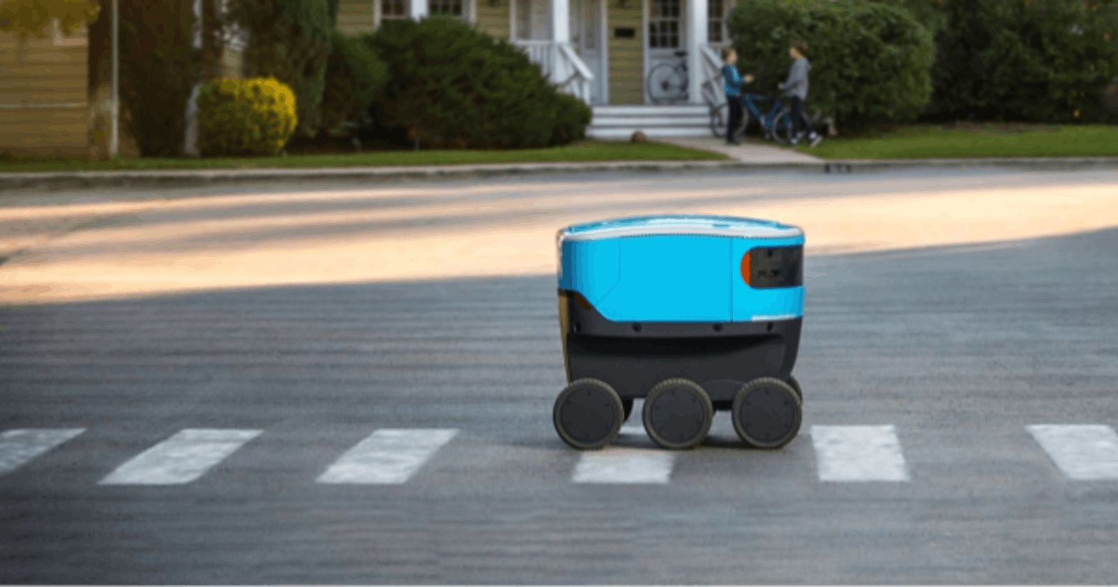 autonomous delivery robot driving on a road