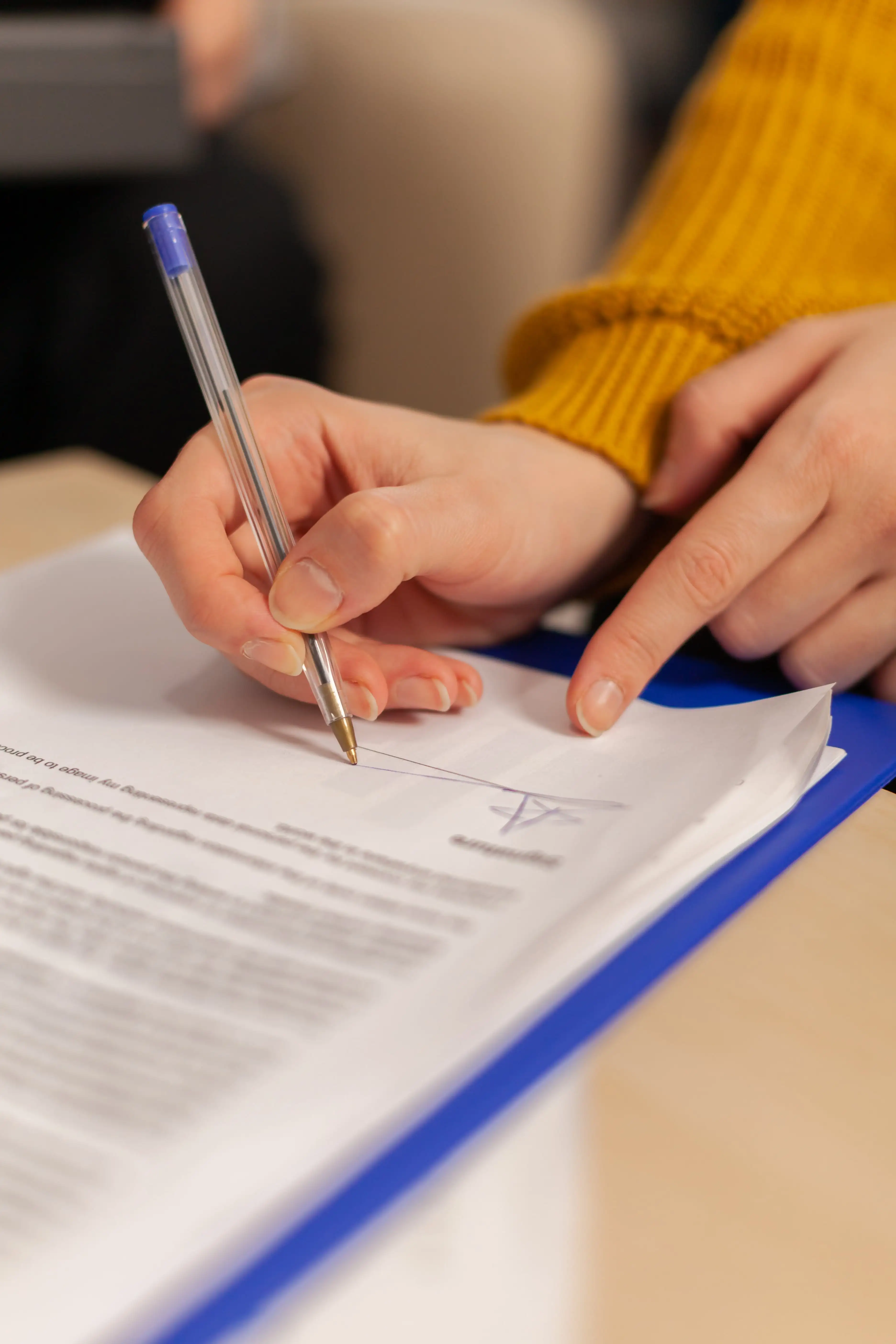 person signing a document